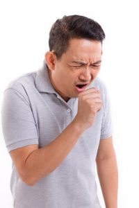 A man coughing